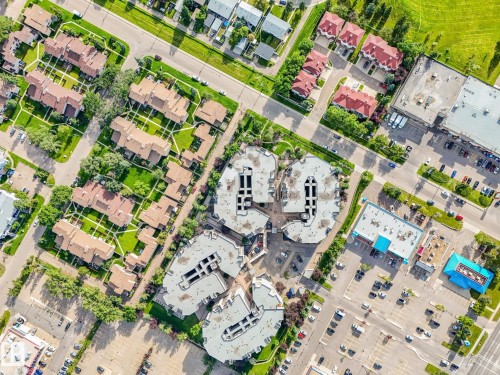Aerial perspective showcasing a mixed-use community with residential and commercial properties - 150 4827 104A Street, Edmonton, AB 