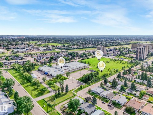 Aerial perspective showcasing a developed neighborhood with residential properties, commercial structures, and green spaces - 150 4827 104A Street, Edmonton, AB 