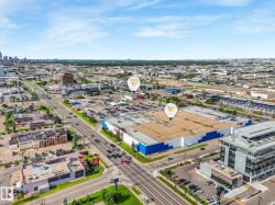 Expansive commercial property featuring a large-format retail building with a blue and white facade, extensive surface parking, and multiple access points - 