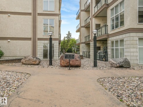 Modern apartment complex exterior featuring stucco siding with stone accents - 150 4827 104A Street, Edmonton, AB 