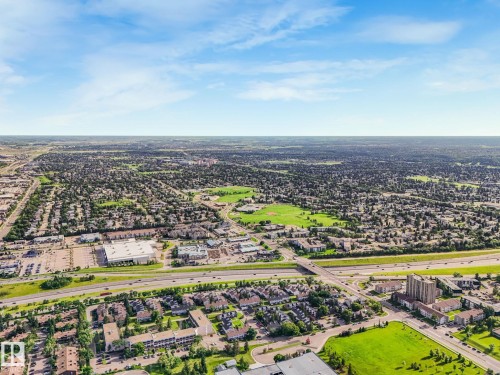 Expansive aerial view showcasing a developed urban landscape with diverse residential and commercial structures - 150 4827 104A Street, Edmonton, AB 