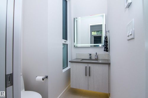 Modern floating vanity with a gray countertop and integrated sink - 13218 102 Avenue, Edmonton, AB 
