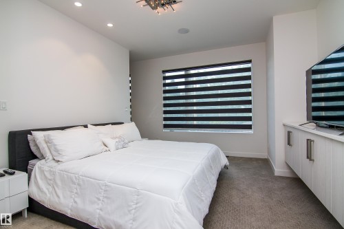 Recessed lighting complements a modern ceiling fixture - 13218 102 Avenue, Edmonton, AB 