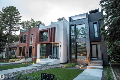 Contemporary exterior featuring dark brick, large windows, and a sleek entry - 13218 102 Avenue, Edmonton, AB 