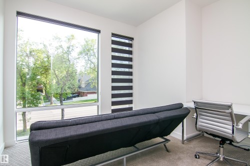 Room featuring expansive window, neutral carpet flooring, and white walls - 13218 102 Avenue, Edmonton, AB 