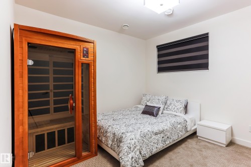 Dedicated sauna space featuring a wood-frame enclosure with a glass door - 13218 102 Avenue, Edmonton, AB 