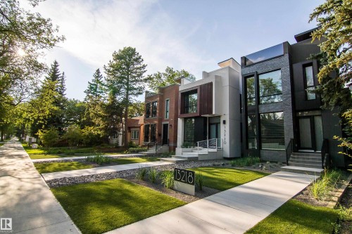 Modern architectural exterior featuring a dark brick facade and large windows - 13218 102 Avenue, Edmonton, AB 