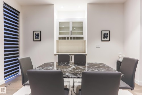 Built-in wet bar featuring glass-front cabinetry and integrated wine storage - 13218 102 Avenue, Edmonton, AB 