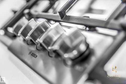 Stainless steel gas cooktop with heavy-duty grates and four control knobs - 13218 102 Avenue, Edmonton, AB 