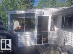 Screened porch addition with a white frame and white siding - 
