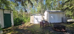 Three detached utility sheds provide ample storage - 