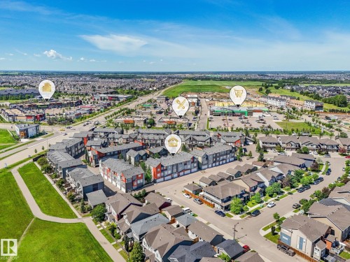 Aerial perspective showcasing a residential area with diverse housing styles, including multi-story townhomes and detached residences - 55 4470 Prowse Road, Edmonton, AB 