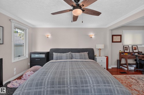 Ceiling fan with wooden blades, crown molding, wall-mounted sconces, and hardwood flooring - 11015 122 Street, Edmonton, AB 