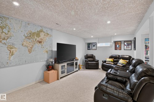 Finished lower level featuring recessed lighting, light-colored carpeting, a window, and built-in shelving - 11015 122 Street, Edmonton, AB 