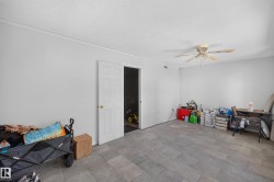 Spacious room featuring light gray tile flooring and white painted walls - 