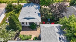 Expansive brick paver patio with surrounding landscaping - 