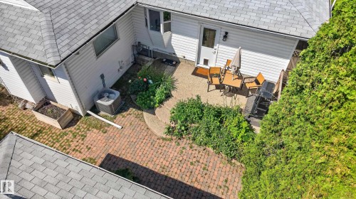 Rear patio with brick paver and concrete hardscaping - 11015 122 Street, Edmonton, AB 