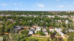 Expansive residential area featuring numerous mature trees and a mix of single-family homes - 