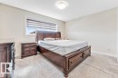 Bedroom featuring neutral wall paint, light-colored carpeting, and a window with horizontal blinds - 1715 27 Street, Edmonton, AB 