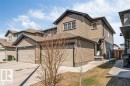 Two-story property featuring tan horizontal siding with dark trim accents - 1715 27 Street, Edmonton, AB 