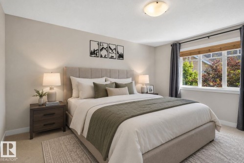 Room featuring a large window with natural wood blinds, light-colored walls, and a ceiling-mounted light fixture - 89 9535 217 Street, Edmonton, AB 