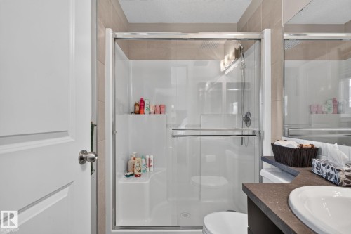 Walk-in shower with clear glass enclosure and integrated seating - 89 9535 217 Street, Edmonton, AB 