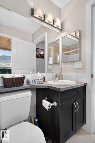 Contemporary vanity with an integrated sink and dark cabinetry - 89 9535 217 Street, Edmonton, AB 