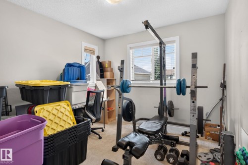 Carpeted room featuring light neutral wall paint and a window with horizontal blinds - 89 9535 217 Street, Edmonton, AB 