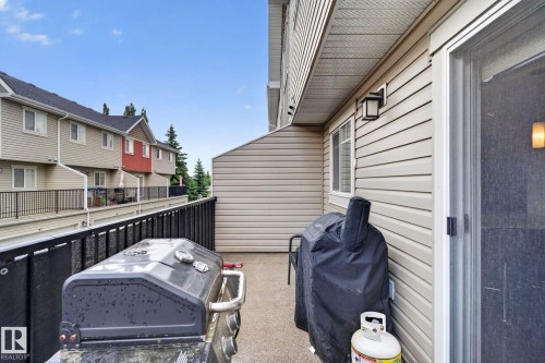 Patio area featuring a concrete surface and black metal railing - 89 9535 217 Street, Edmonton, AB 