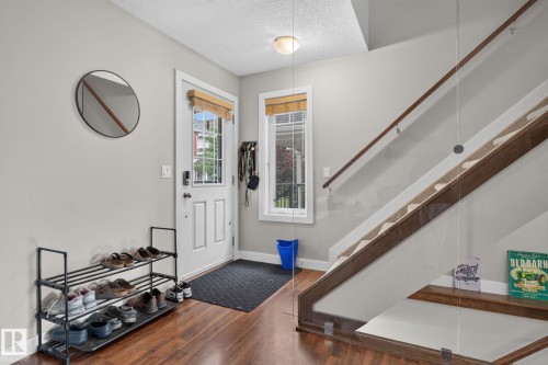 Entryway featuring wood-finish flooring and light-toned walls - 89 9535 217 Street, Edmonton, AB 