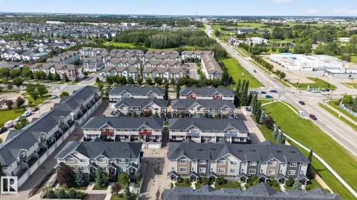Aerial perspective showcasing a residential community with numerous townhome-style properties - 89 9535 217 Street, Edmonton, AB 