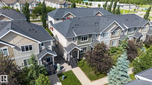Row of townhomes featuring gabled entries, shingled roofs, and varied siding textures - 89 9535 217 Street, Edmonton, AB 