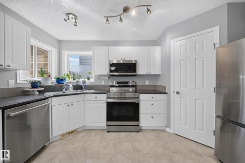 709 83 St Sw, Edmonton, AB - Indoor Photo Showing Kitchen With Stainless Steel Kitchen With Double Sink