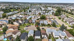 Residential neighborhood featuring various housing styles and abundant mature trees - 