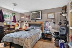 Bedroom featuring wood-finish flooring and a window with natural light - 