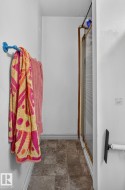 Shower enclosure with clear glass door and a tiled flooring - 