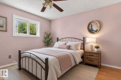 Inviting room featuring a window with white trim, wood-finish flooring, a ceiling fan, and painted walls - 