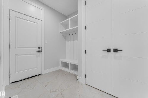 Entryway featuring a built-in bench with storage cubbies and coat hooks - 2611 62 Avenue, Rural Leduc County, AB - Indoor Photo Showing Other Room