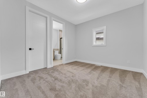 Carpeted interior space featuring light grey walls, white trim, a single window with white framing, and a flush-mount ceiling light - 2611 62 Avenue, Rural Leduc County, AB - Indoor Photo Showing Other Room