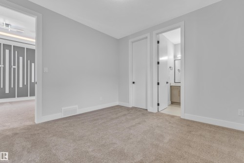 Carpeted interior with light grey walls and white trim - 2611 62 Avenue, Rural Leduc County, AB - Indoor Photo Showing Other Room