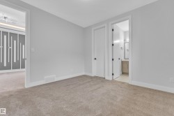 Carpeted interior with light grey walls and white trim - 