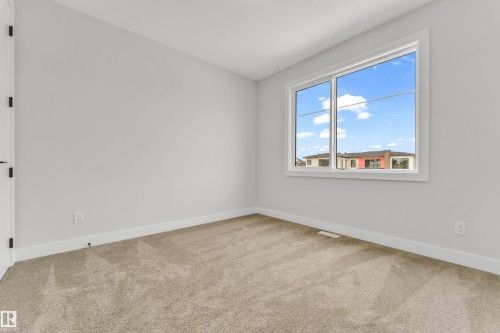 Neutral tone wall finishes complemented by white trim - 2611 62 Avenue, Rural Leduc County, AB - Indoor Photo Showing Other Room