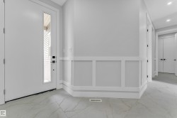Entryway with large format tile flooring and wainscoting - 