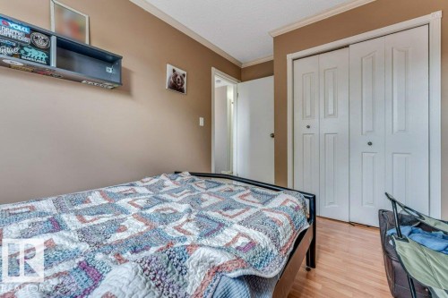 Bedroom featuring warm neutral wall tones and wood-finish flooring - 14530 37 Street, Edmonton, AB 