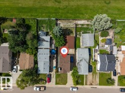 Single-family residence with a brown shingle roof and a concrete driveway - 