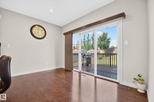 Sliding glass doors opening to an exterior wood deck - 1512 Cunningham Cape, Edmonton, AB 