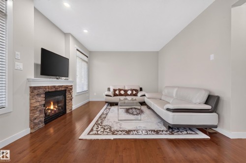Living area featuring wood-finish flooring and light-toned walls - 1512 Cunningham Cape, Edmonton, AB 