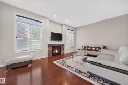 Living area featuring rich wood-finish flooring and neutral wall tones - 