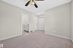 Neutral-toned wall paint with a ceiling fan, plush carpet, and white trim - 