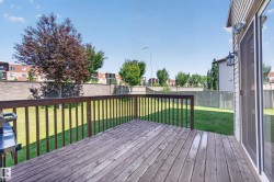 Exterior wood deck with railings and a sliding glass door - 